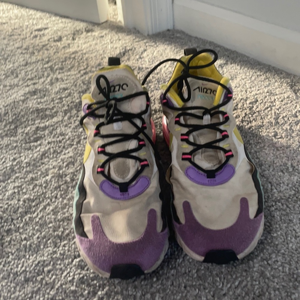 Green yellow pink white and purple Nike reacts
